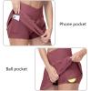 imageTHE GYM PEOPLE Womens Cross Waist Tennis Skirts with Cutting Hem Golf Skorts with Inner Mesh Pockets ShortsRed